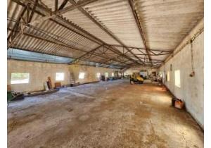 For sale: Large modern house with industrial barns, suitable for many activities.